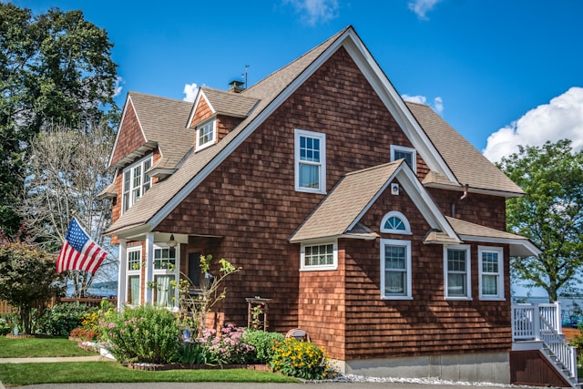 brown small home in usa with american flag
