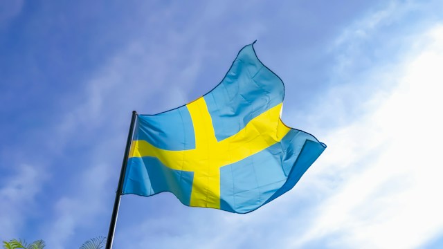 Swedish flag flying against blue sky
