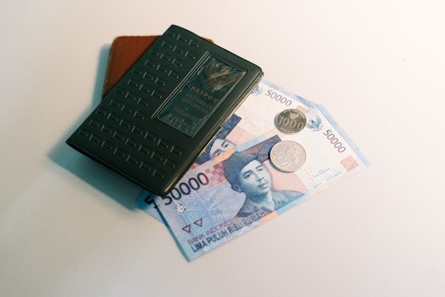indonesia money and passport on table