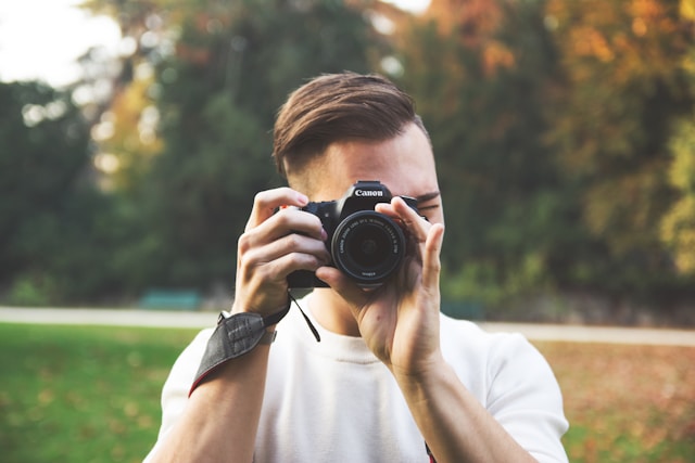 Man taking photo on Canon camera